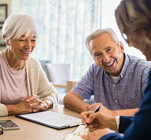Older couple meeting with an AgeSMART care advisor to begin a personalized in-home senior care plan with clear next steps