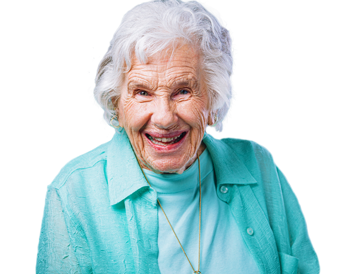 Smiling older woman with white hair wearing a teal shirt and necklace